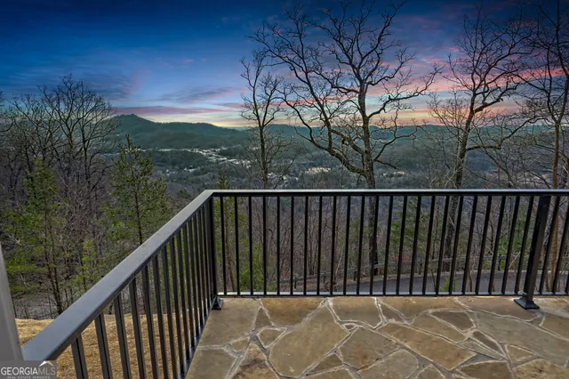a balcony with wooden fence and trees