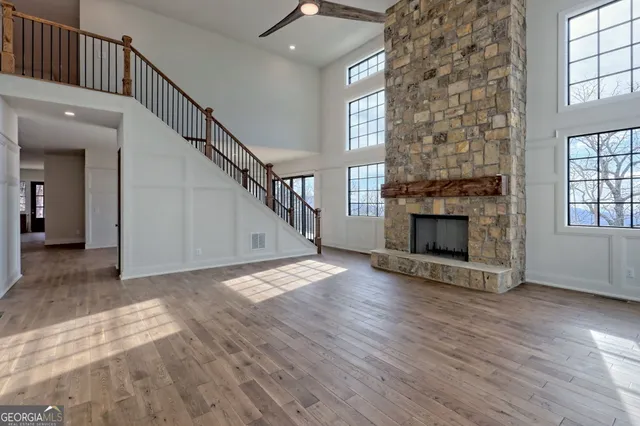 a view of a hallway with wooden floor and staircase