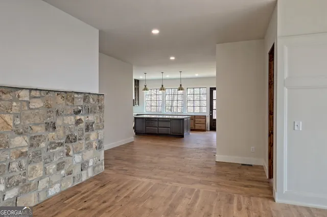 a view of a livingroom with a ceiling fan and wooden floor
