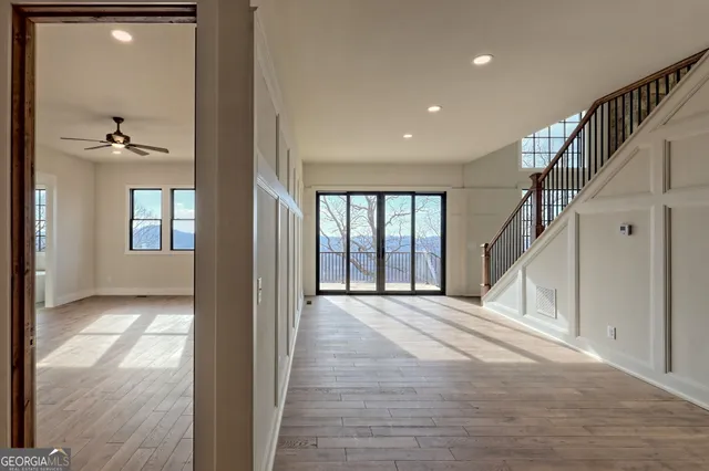 a view of an empty room with wooden floor