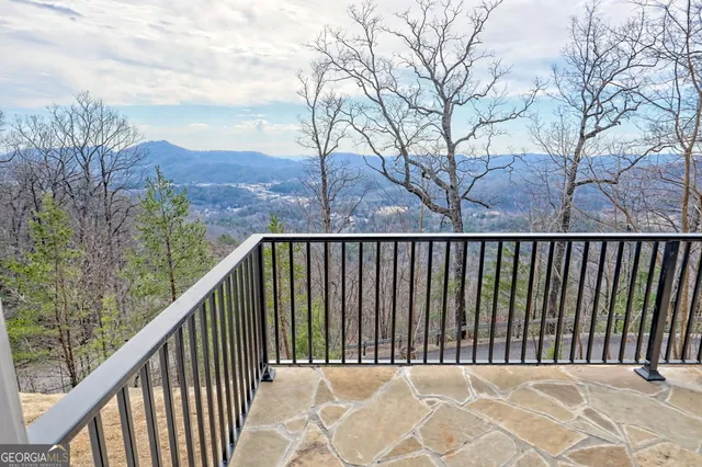 a bathroom with a toilet a sink a mirror and shower