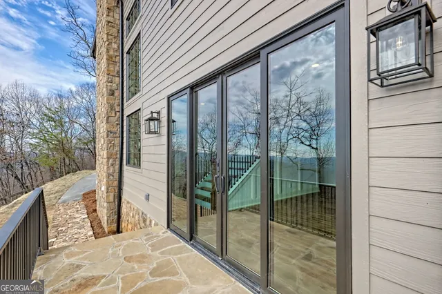 a bathroom with a toilet a sink and glass door