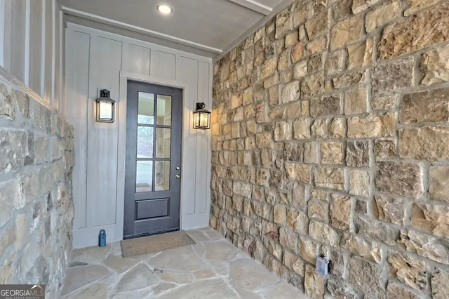 an entryway and livingroom with wooden floor