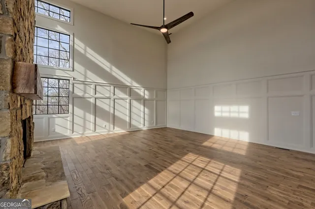 a kitchen with a stove and a wooden floor