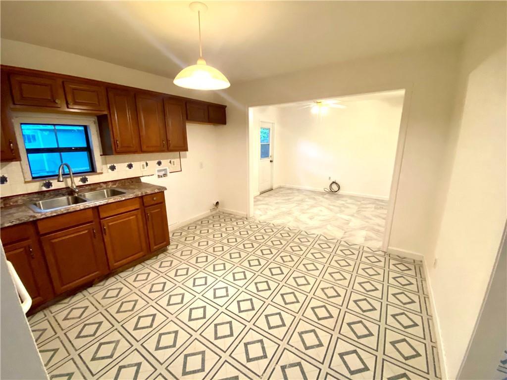 6211 Club Terrace Austin, TX 78741 - Photo 12 of 25 a kitchen with a sink cabinets and window