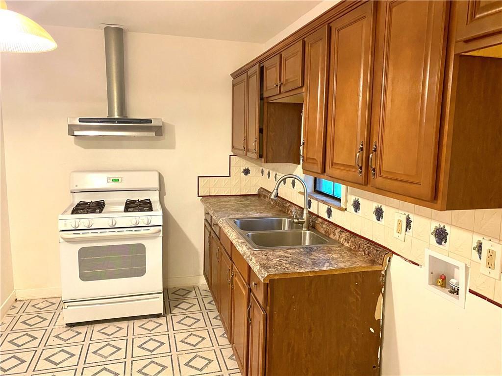 6211 Club Terrace Austin, TX 78741 - Photo 15 of 25 a kitchen with stainless steel appliances granite countertop a sink stove and cabinets