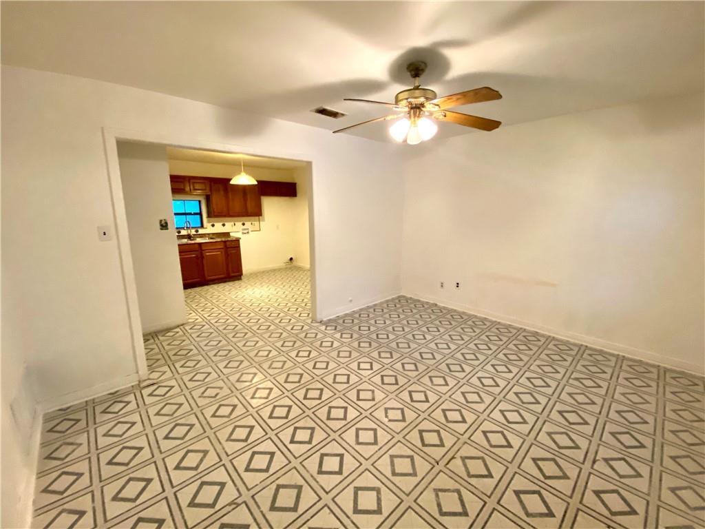 6211 Club Terrace Austin, TX 78741 - Photo 16 of 25 a view of a livingroom with wooden floor and a ceiling fan