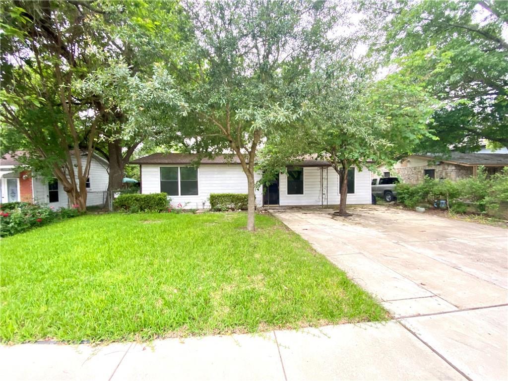 6211 Club Terrace Austin, TX 78741 - Photo 3 of 25 a front view of a house with a yard and trees