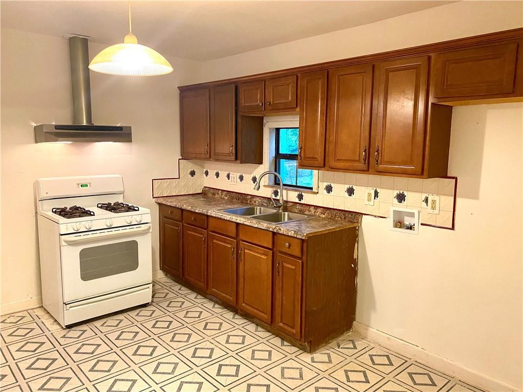 6211 Club Terrace Austin, TX 78741 - Photo 10 of 25 a kitchen with stainless steel appliances granite countertop a sink stove and refrigerator