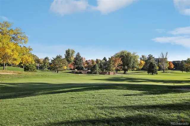a view of a bench in the garden near a lake