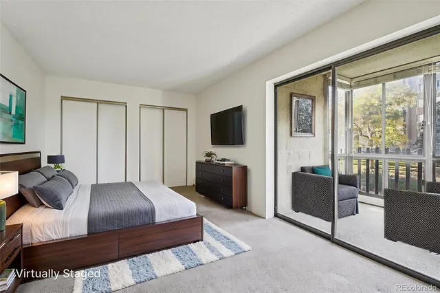 a bedroom with a balcony a bed and a television