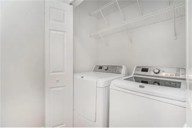 a view of washer and dryer with kitchen in the background