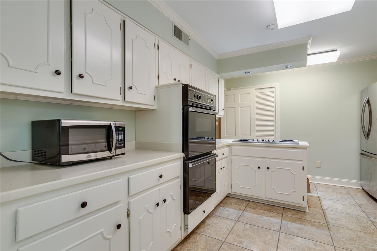 4515 Aldersgate Road, Unit 2 Memphis, TN 38117 - Photo 14 of 25 a kitchen with granite countertop white cabinets and stainless steel appliances