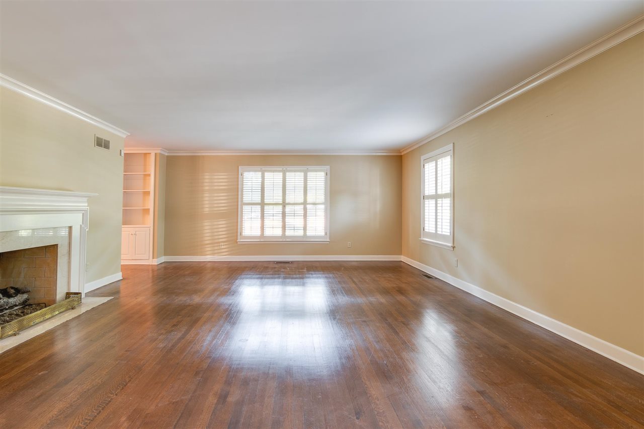 4515 Aldersgate Road, Unit 2 Memphis, TN 38117 - Photo 5 of 25 a view of an empty room with wooden floor and a window