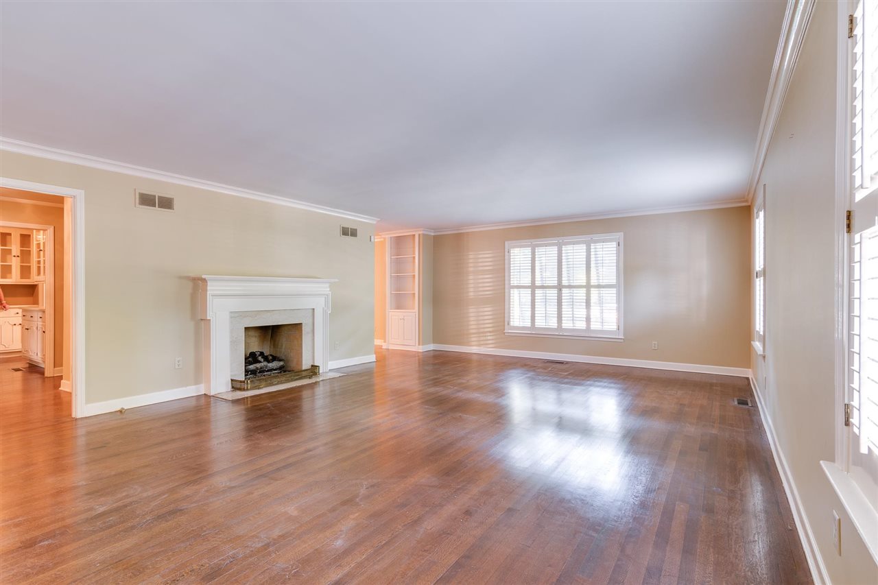 4515 Aldersgate Road, Unit 2 Memphis, TN 38117 - Photo 6 of 25 a view of empty room with wooden floor and fireplace