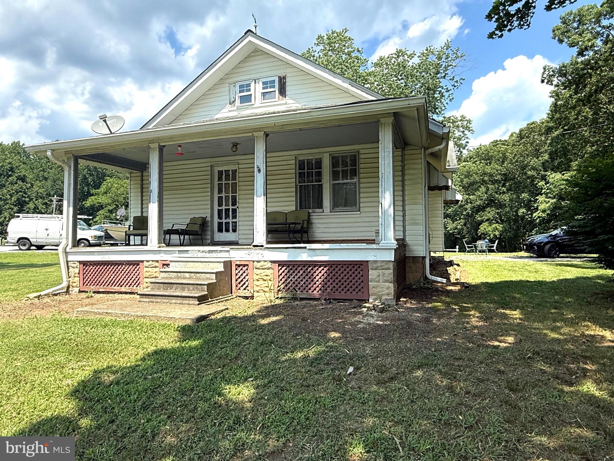 9860 H G Trueman Road Lusby, MD 20657 - Photo 2 of 12 a view of a house with a yard patio and swimming pool