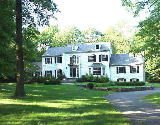 71 Clapboard Ridge Road Greenwich, CT 06830 - Photo 1 of 1 a front view of a house with a garden