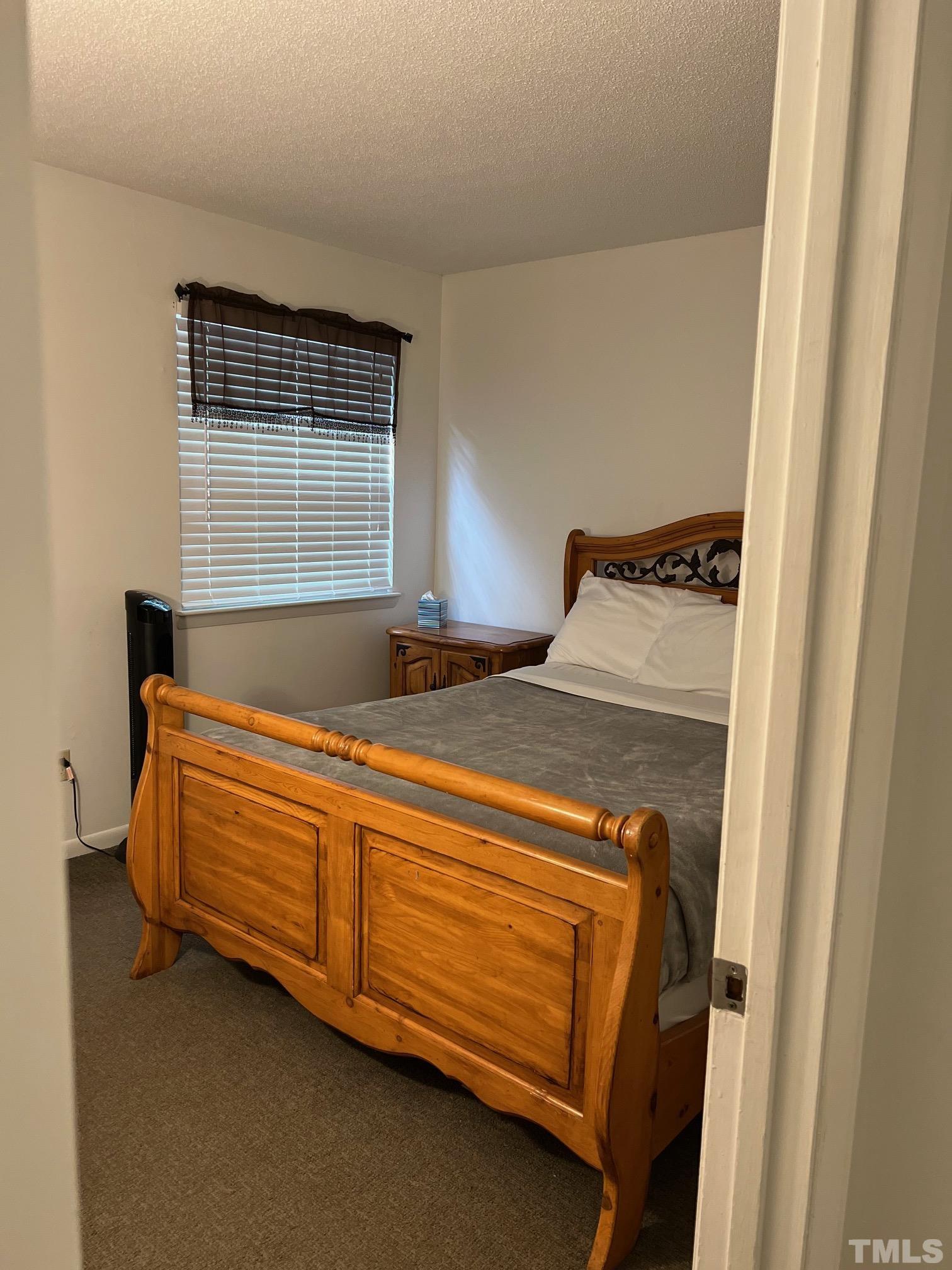 700 Godwin Court Raleigh, NC 27606 - Photo 12 of 20 a bed sitting in a bedroom next to a window