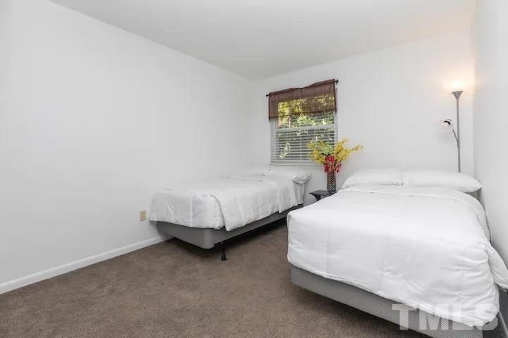 700 Godwin Court Raleigh, NC 27606 - Photo 13 of 20 a bedroom with two beds and painting on the wall