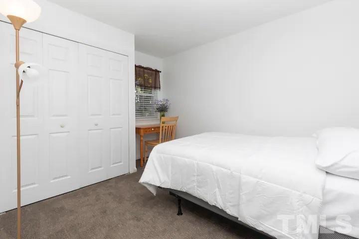 700 Godwin Court Raleigh, NC 27606 - Photo 15 of 20 a bedroom with a bed and a table