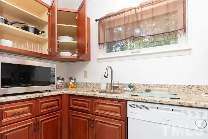 700 Godwin Court Raleigh, NC 27606 - Photo 7 of 20 a kitchen with stainless steel appliances granite countertop a sink and a microwave