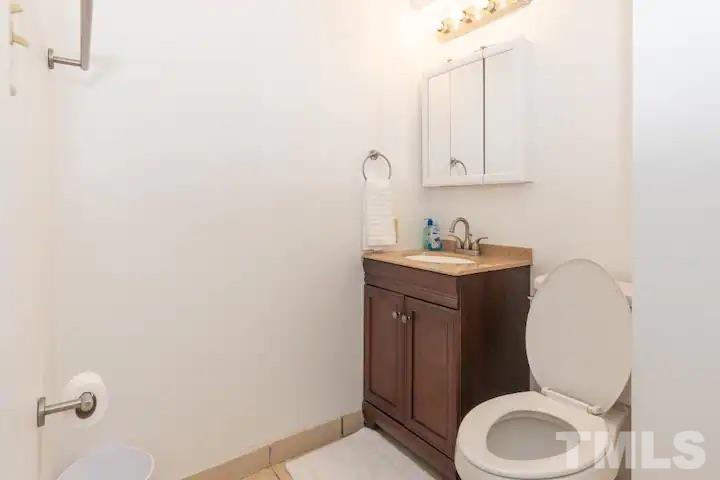 700 Godwin Court Raleigh, NC 27606 - Photo 9 of 20 a bathroom with a toilet sink vanity and mirror