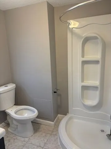 a white toilet sitting next to a bathroom sink