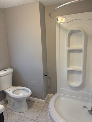 193 Snell Street, Unit 2 Fall River, MA 02721 - Photo 17 of 19 a white toilet sitting next to a bathroom sink