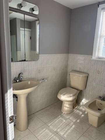 193 Snell Street, Unit 2 Fall River, MA 02721 - Photo 19 of 19 a bathroom with a toilet sink and mirror