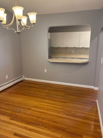 193 Snell Street, Unit 2 Fall River, MA 02721 - Photo 5 of 19 a view of a room with wooden floor and utility