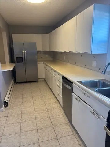 a kitchen with a sink a stove and cabinets