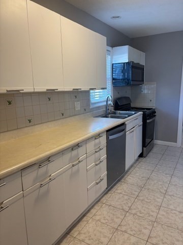 193 Snell Street, Unit 2 Fall River, MA 02721 - Photo 10 of 19 a kitchen with stainless steel appliances granite countertop a sink and cabinets