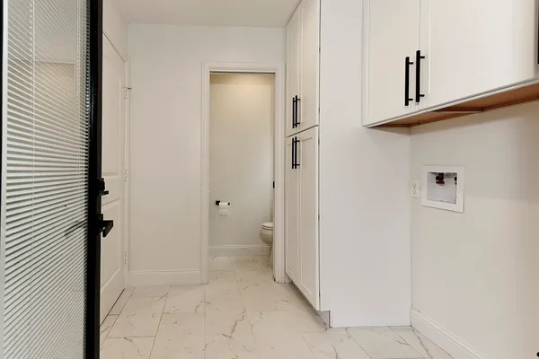a bathroom with a granite countertop sink a toilet and a mirror