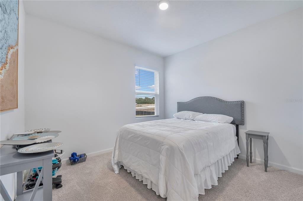 9201 Potomac Drive Fort Pierce, FL 34945 - Photo 13 of 24 a bedroom with a bed and a window