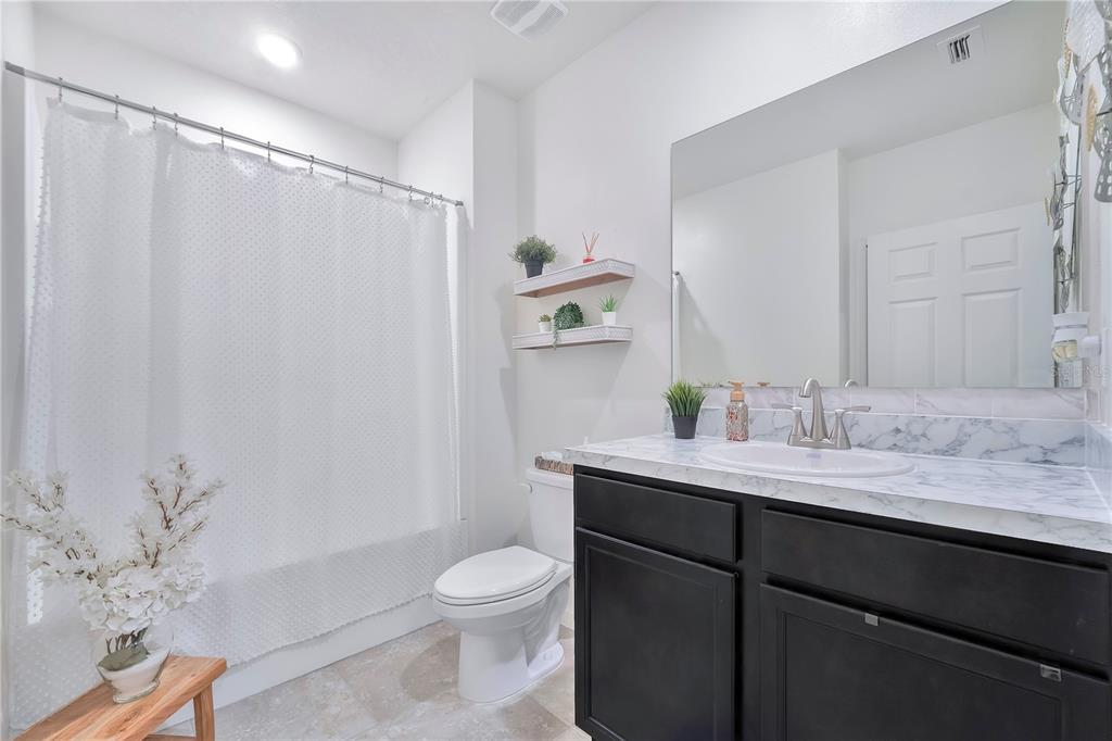 9201 Potomac Drive Fort Pierce, FL 34945 - Photo 14 of 24 a bathroom with a granite countertop sink toilet and shower