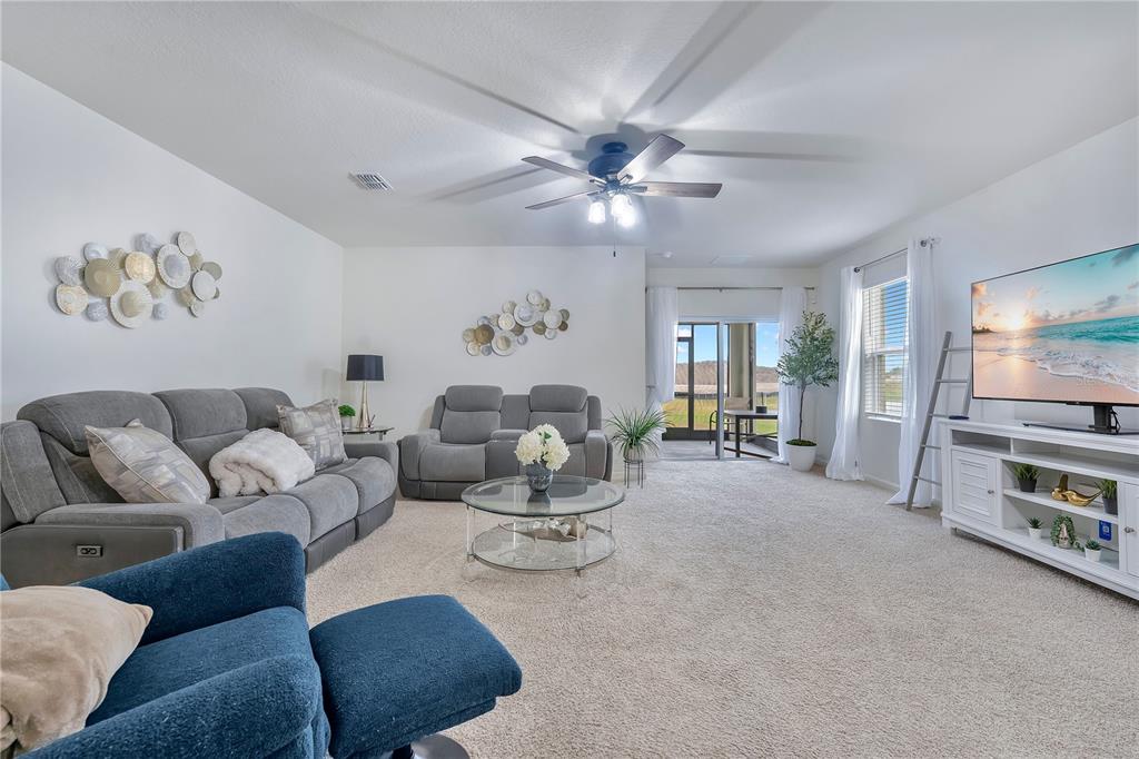 9201 Potomac Drive Fort Pierce, FL 34945 - Photo 2 of 24 a living room with furniture and a flat screen tv