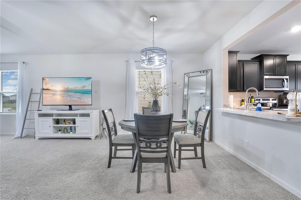 9201 Potomac Drive Fort Pierce, FL 34945 - Photo 6 of 24 a dining room with furniture a chandelier and window