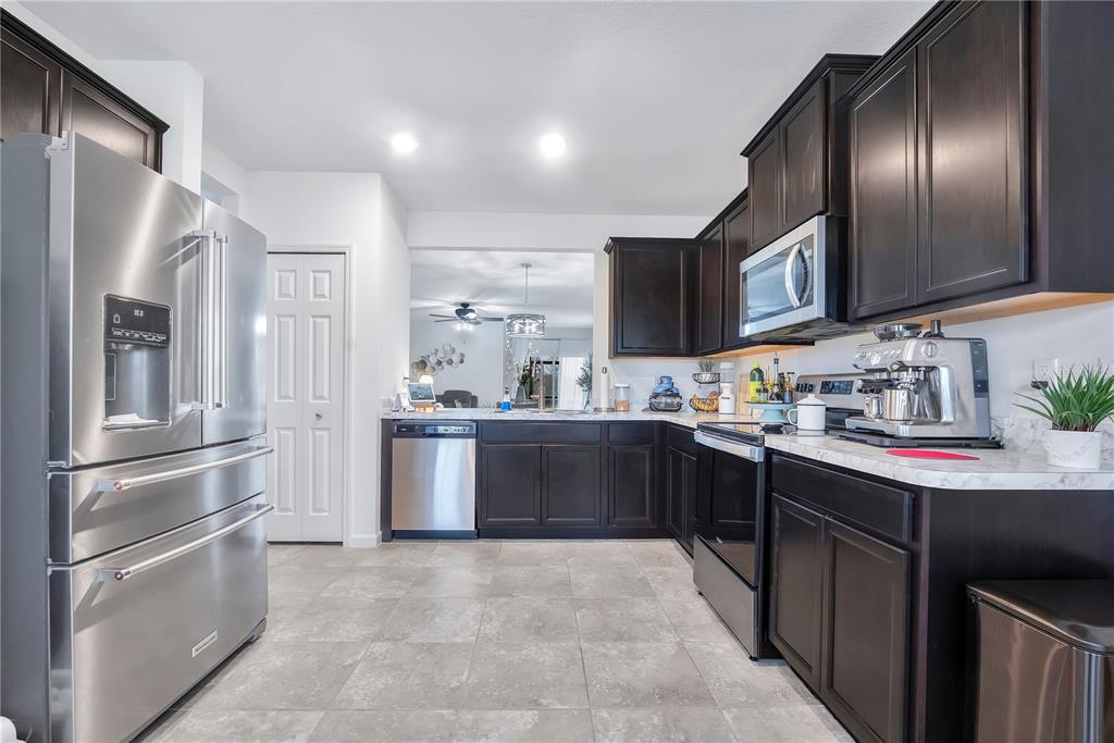 9201 Potomac Drive Fort Pierce, FL 34945 - Photo 8 of 24 a kitchen with stainless steel appliances granite countertop a refrigerator sink and cabinets