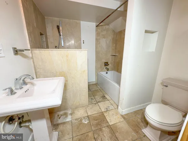 a bathroom with a sink a toilet and bathtub