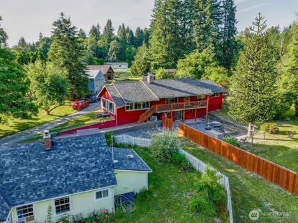 an aerial view of a house with a yard basket ball court and outdoor seating