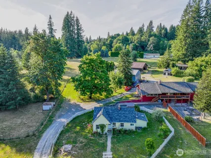 an aerial view of a house with swimming pool and garden