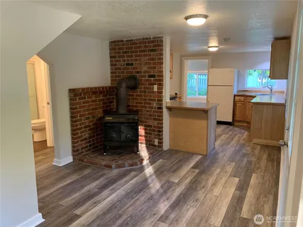 a kitchen with stainless steel appliances granite countertop white cabinets and a sink