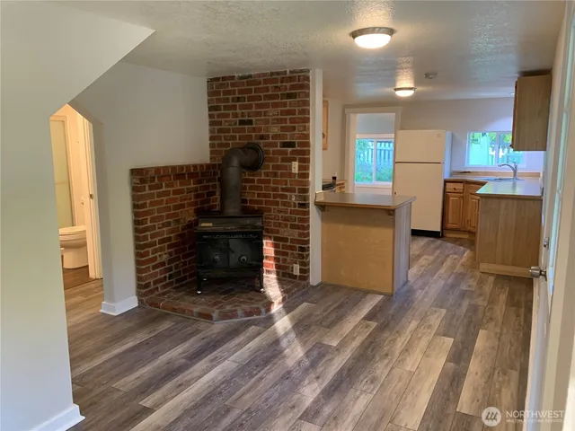 a kitchen with stainless steel appliances granite countertop white cabinets and a sink