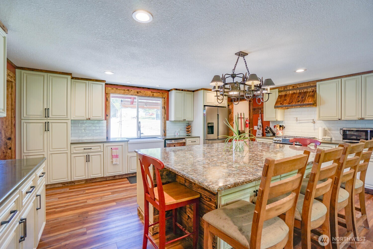 19910 Northeast 356th Street Yacolt, WA 98675 - Photo 2 of 37 a kitchen with a table chairs stove and cabinets