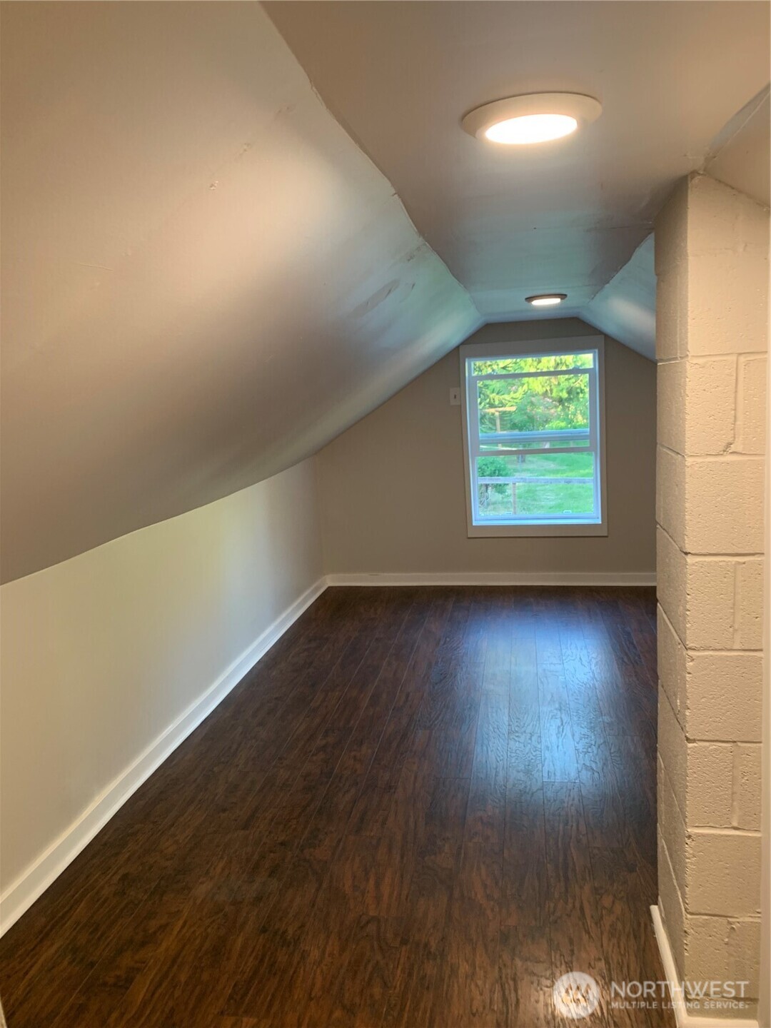 19910 Northeast 356th Street Yacolt, WA 98675 - Photo 24 of 37 an empty room with wooden floor and windows