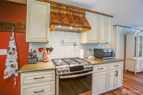 a kitchen with stainless steel appliances granite countertop a stove and a refrigerator
