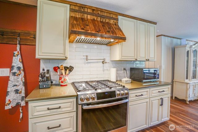a kitchen with stainless steel appliances granite countertop a stove and a refrigerator