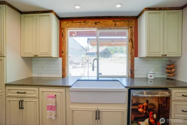 a kitchen with stainless steel appliances granite countertop a sink and a cabinets