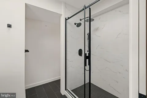 a bathroom with a glass shower door