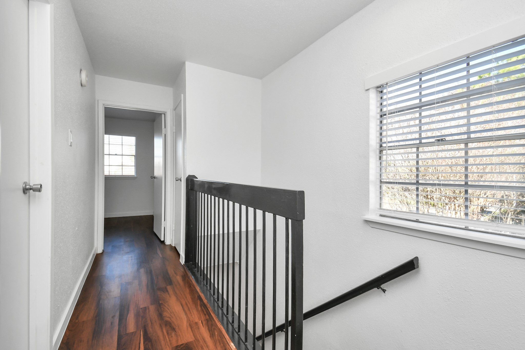 2002 Gentryside Drive, Unit 113 Houston, TX 77077 - Photo 15 of 32 a view of a hallway with wooden floor and stairs